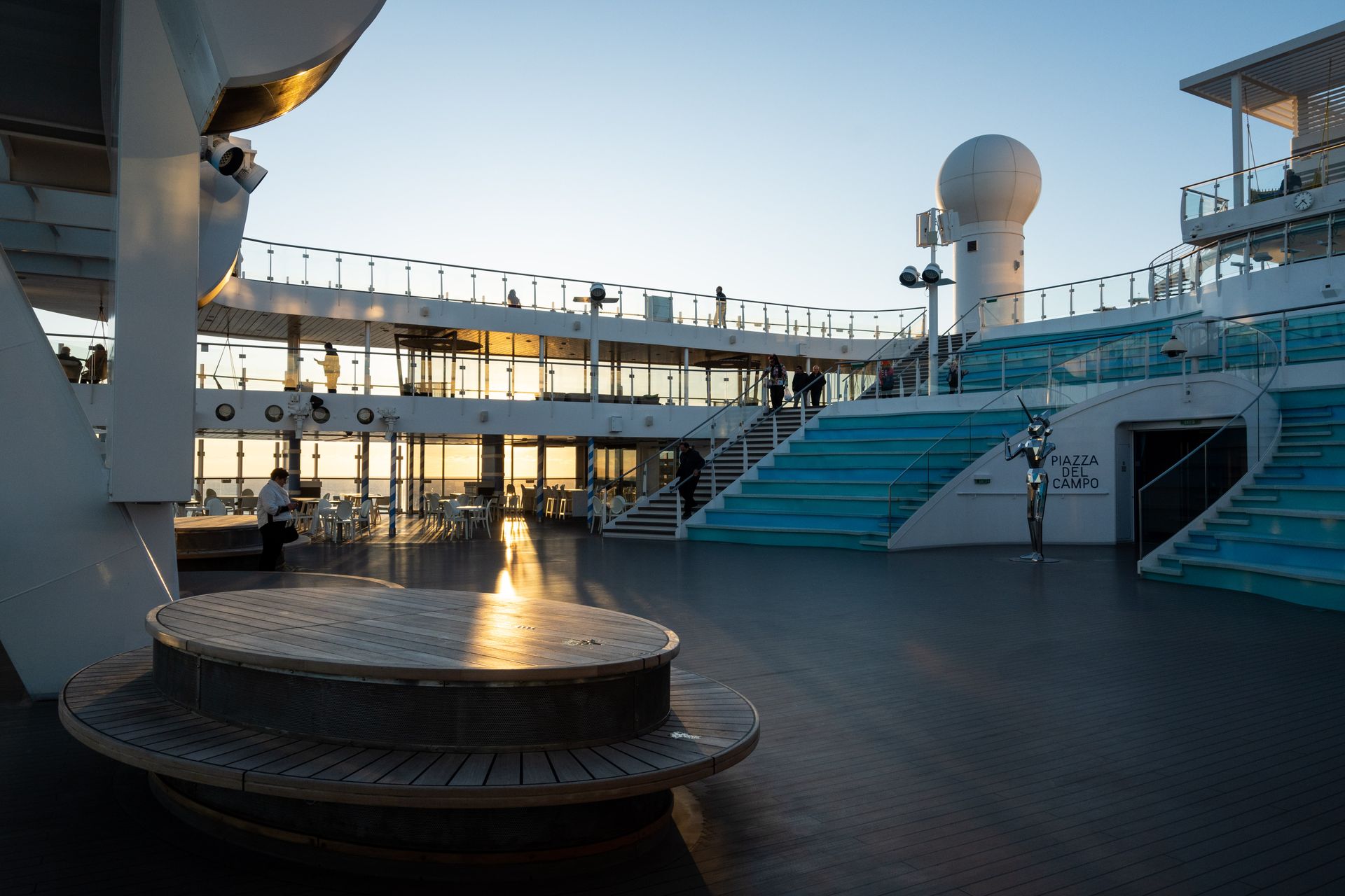 Luxury cruise ship pool deck glowing at dusk